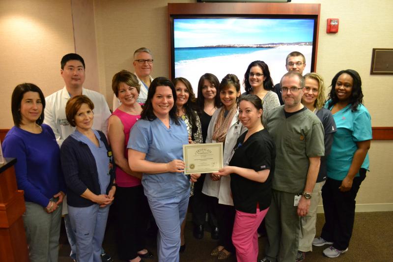 Southcoast Vein Center staff hold a certificate recognizing a three-year accreditation that was awarded by the Intersocietal Accreditation Commission (IAC) for outstanding quality in providing vascular services. The staff members are (from left, front row) Cheryl Jochim, Doreen Lacasse, Janine Holmes, Deb Torres, Goretti Jardin, Diane Rioux, Laura Mathews, Roger Fonteneau, Jeanne Catron, Alisha Todman, (from left, back row) Dr. Richard Pin, Dr. David Gillespie, Tammy Santos, Jessica Martiros, and Jason Robert. COURTESY SOUTHCOAST HEALTH